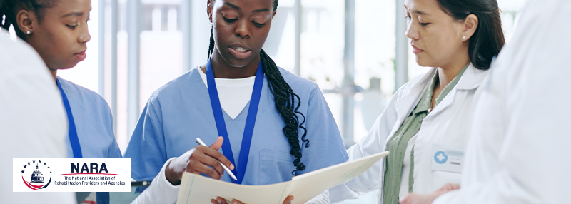 Three medical professional women conferring and looking over papers