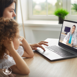 Mom and daughter speaking to doctor through video chat on laptop using telehealth services