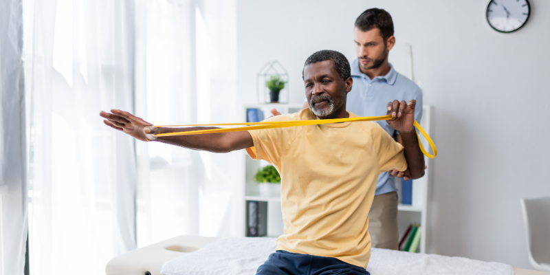 Man receiving physical therapy with PT
